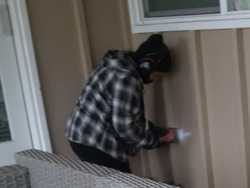 Professional electrician installing an exterior outlet in Vernon