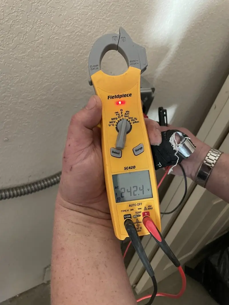 Voltage testing with clamp meter during Outlet Installation in Vernon